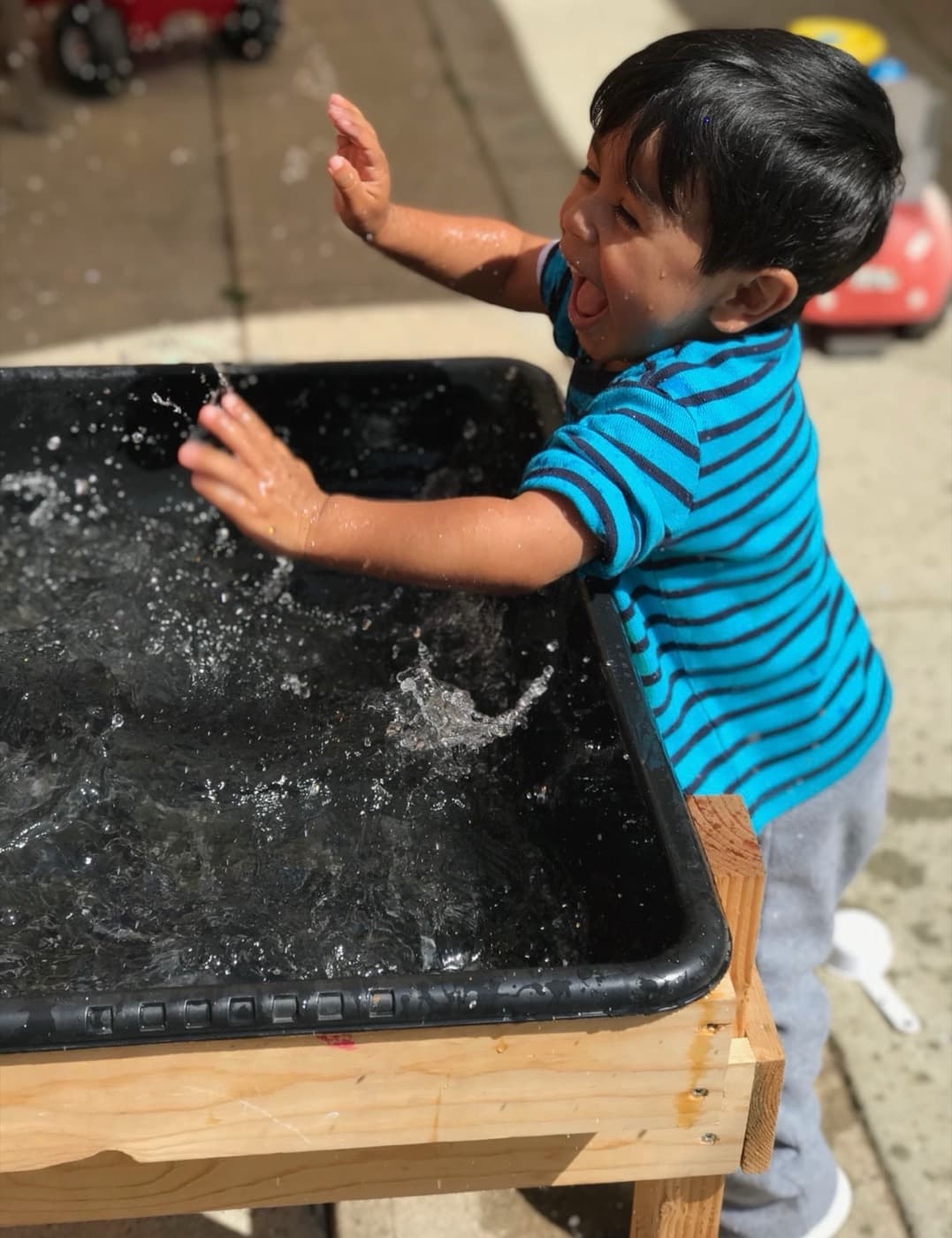 Splashing gleefully at the water table