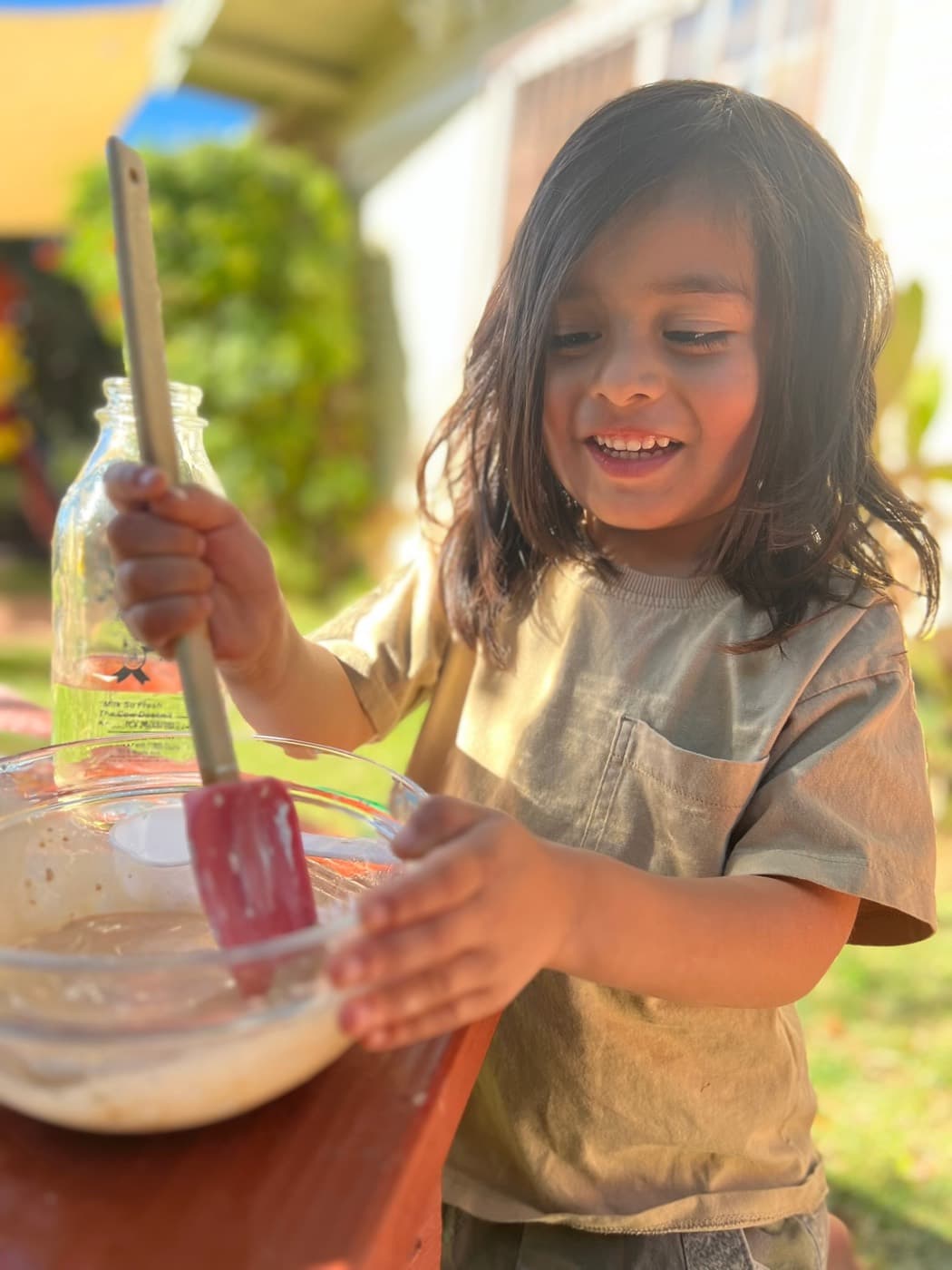 Stirring batter with a red spatula outside