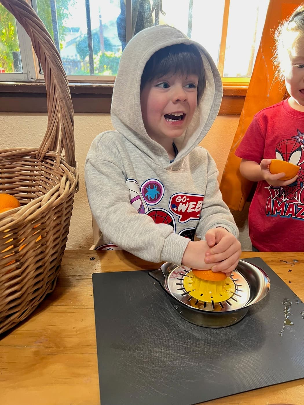 Squeezing a fresh orange on the juicer