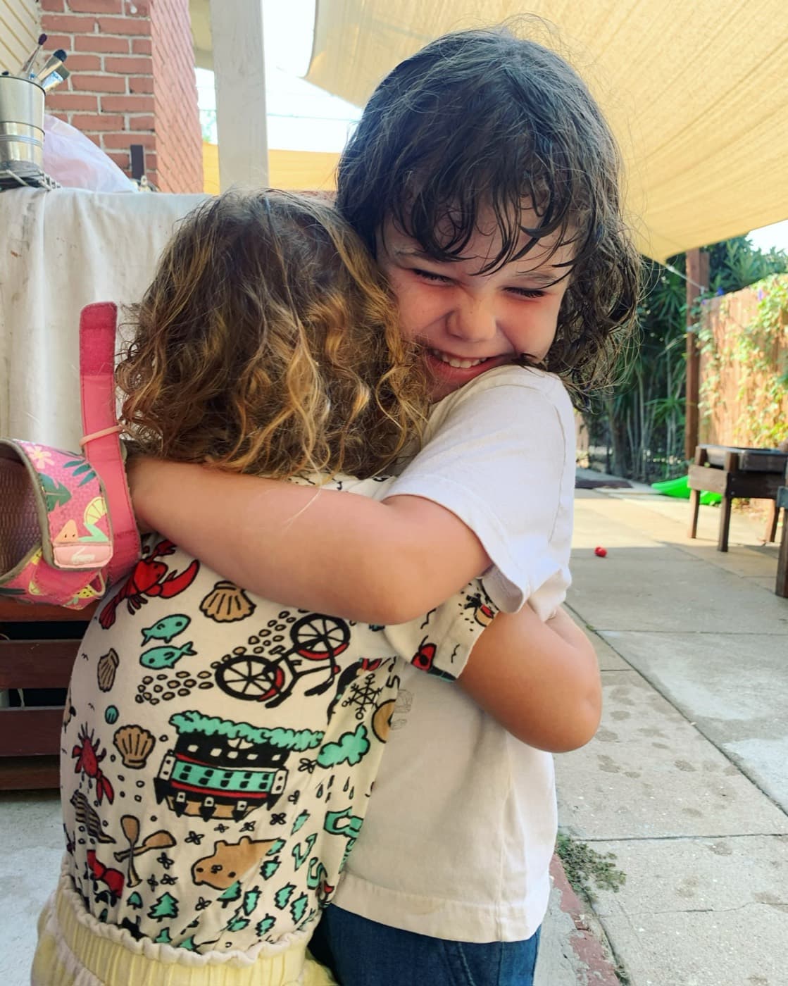 A warm, giggly hug between friends