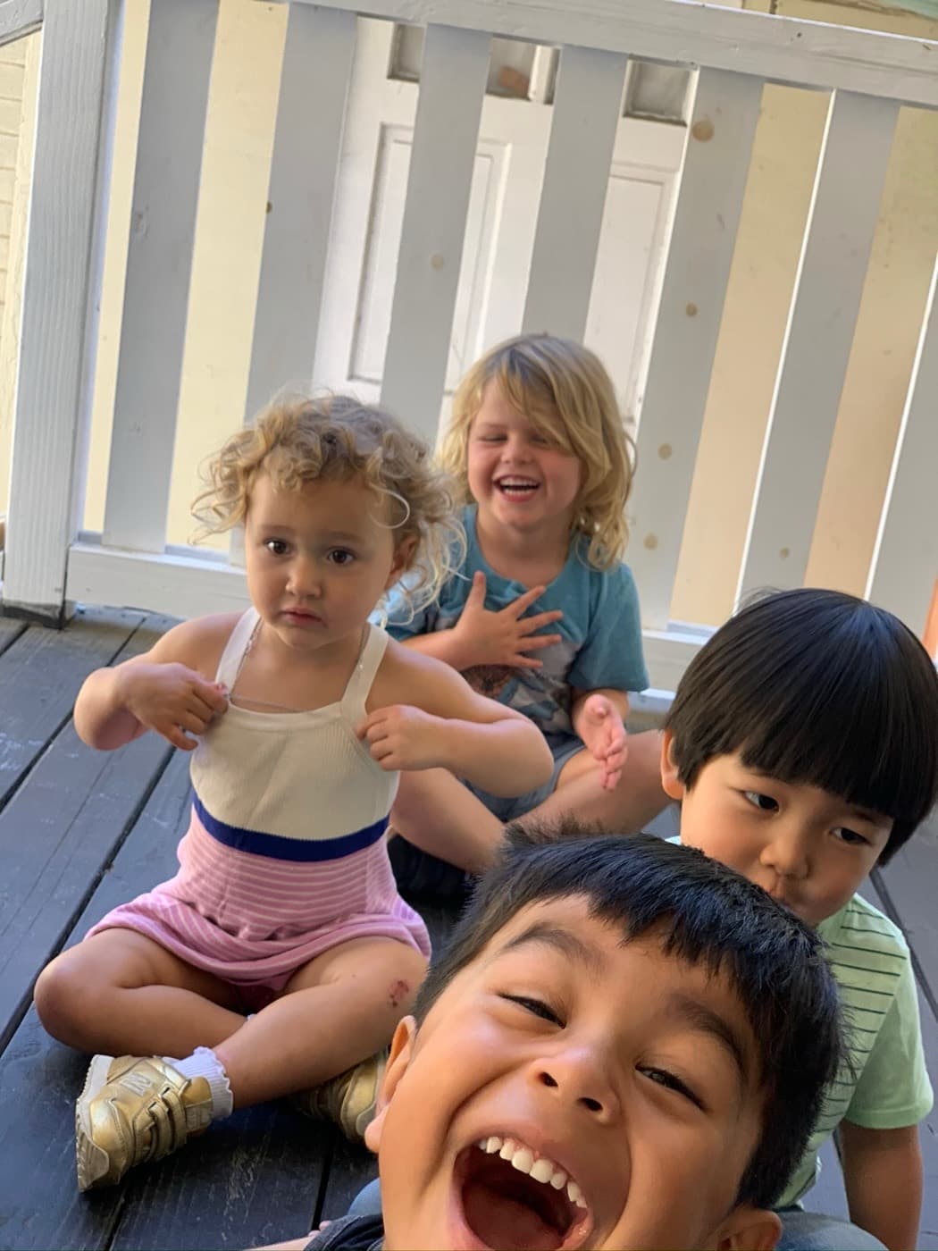 Four friends piling together for a photo