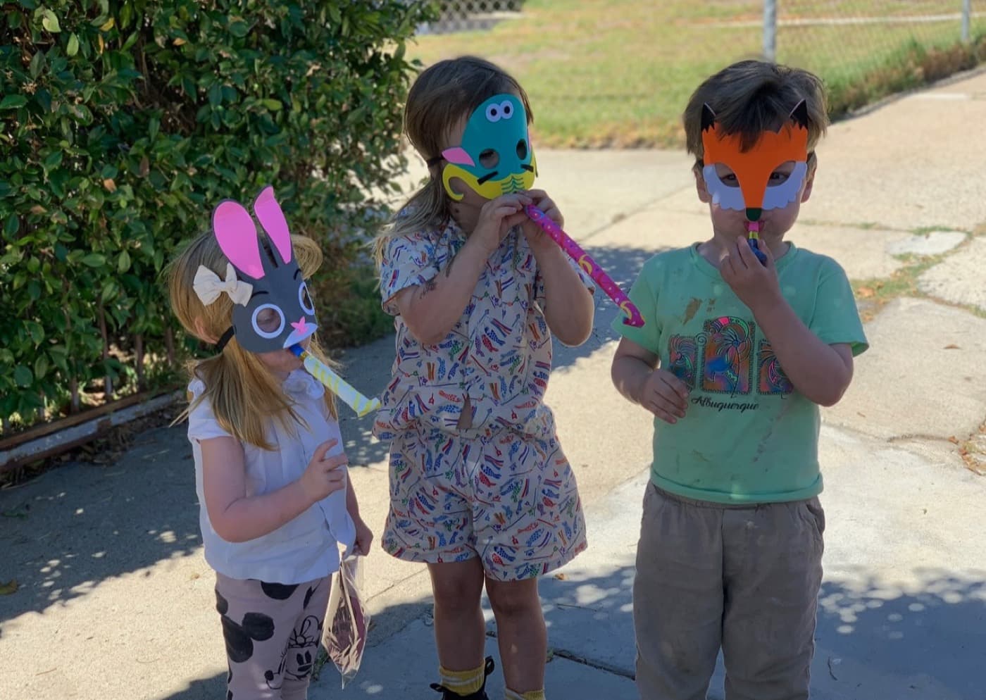 Tooting party horns behind animal masks