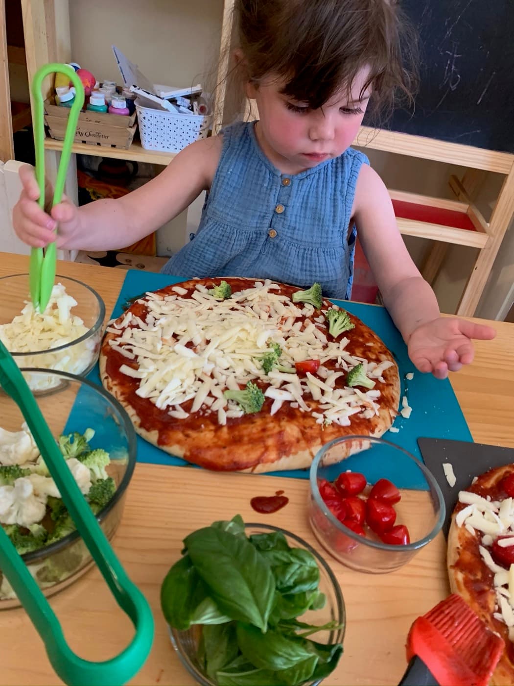 Topping homemade pizza with cheese and veggies